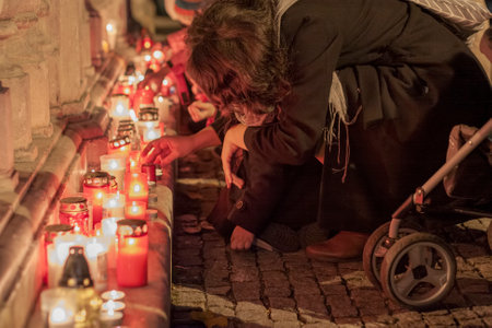 Brno, Czech Republic - November 17, 2019: Woman lights a candle on  celebration 30 years of Velvet Revolution at Liberty Square on November 17, 2019 Brno, Czech Republicのeditorial素材