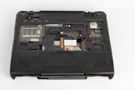 old laptop, removed monitor , keyboard, battery and  floppy disk drive on white backgroundの写真素材