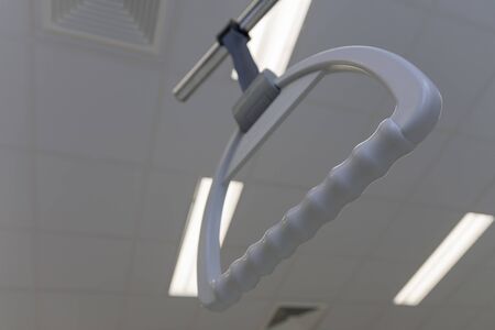 Hospital bed trapeze in intensive care unit in hospital, on background ceiling lightsの写真素材