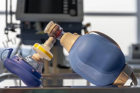 Breathing bag with filter and mask , on background medical ventilator in ICU in hospital, a place where can be treated patients with pneumonia caused by coronavirus covid-19.の写真素材