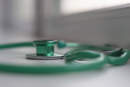 Close up view of green stethoscope  in ICU in hospital, a place where can be treated patients with pneumonia caused by coronavirus covid-19.の写真素材