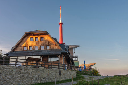 Television transmitter and chalet on Lysa Hora, beskid mountains, Czech republic at summer sunset time.の写真素材