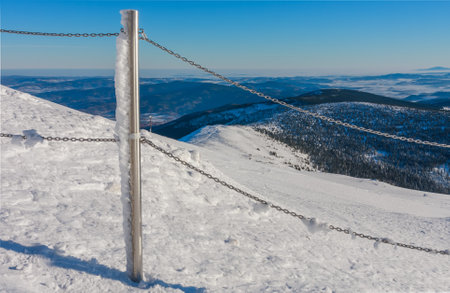 Steel railing tube with a chain, top of path to snezka from pink mountain, krkonose mountain, winter morning.の写真素材