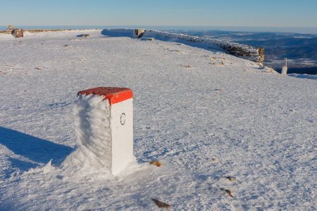 Boundary stone on Snezka, mountain on the border between Czech Republic and Poland, Krkonose mountains, winter morningの写真素材