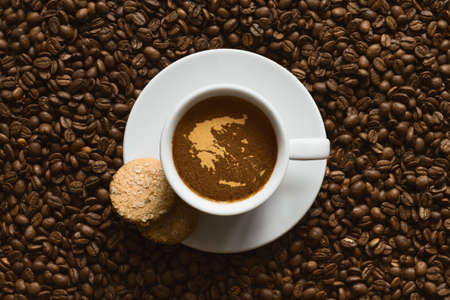Still life photography of hot coffee beverage with map of Greeceの写真素材