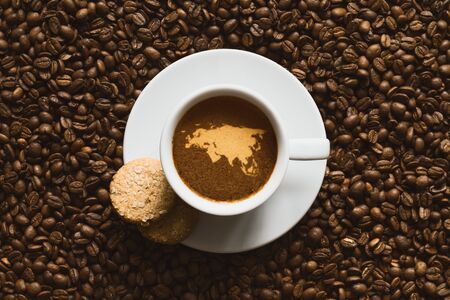 Still life photography of hot coffee beverage with map of Eurasia continentの写真素材