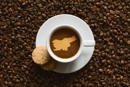 Still life photography of hot coffee beverage with map of Sloveniaの写真素材