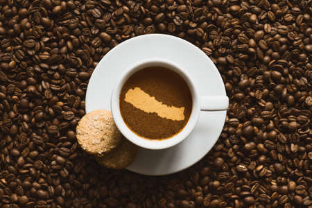Still life photography of hot coffee beverage with map of Nepalの写真素材