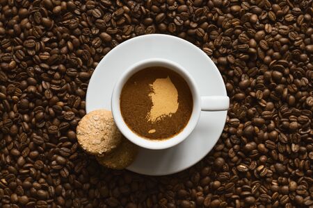 Still life photography of hot coffee beverage with map of South Koreaの写真素材