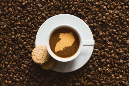 Still life photography of hot coffee beverage with map of Ugandaの写真素材