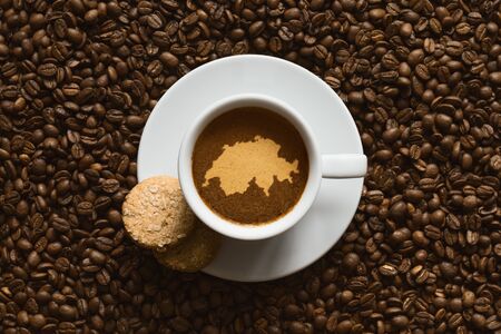 Still life photography of hot coffee beverage with map of Switzerlandの写真素材