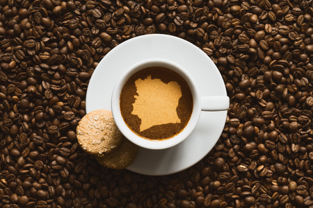 Still life photography of hot coffee beverage with map of Ivory Coastの写真素材