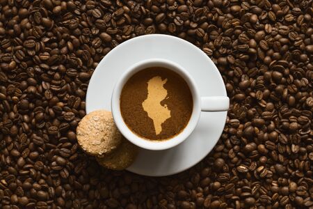 Still life photography of hot coffee beverage with map of Tunisiaの写真素材