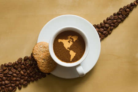 Still life photography of hot coffee beverage with map of America continentの写真素材
