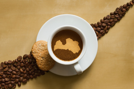 Still life photography of hot coffee beverage with map of Latviaの写真素材