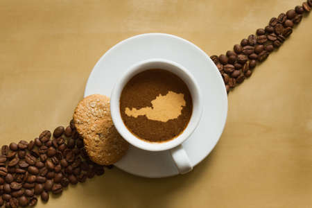Still life photography of hot coffee beverage with map of  Austriaの写真素材