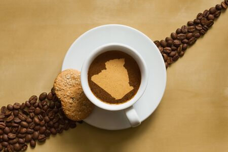 Still life photography of hot coffee beverage with map of Algeriaの写真素材