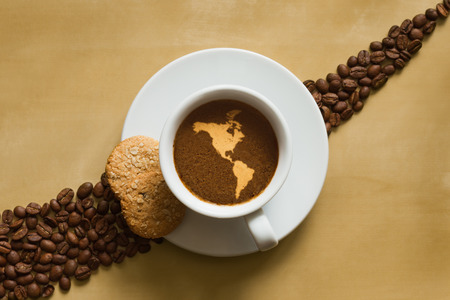 Still life photography of hot coffee beverage with map of America continent (without Greenland)の写真素材
