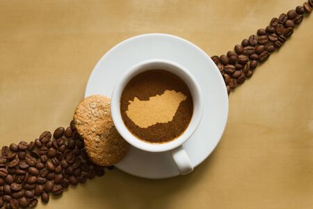 Still life photography of hot coffee beverage with map of Hungaryの写真素材