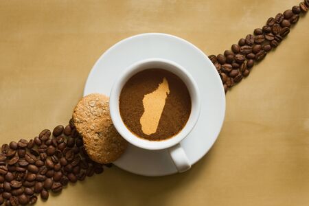 Still life photography of hot coffee beverage with map of Madagascarの写真素材