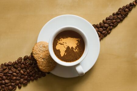Still life photography of hot coffee beverage with map of Afro-EurAsiaの写真素材