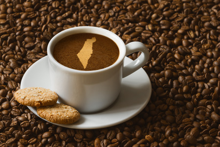 Still life photography of hot coffee beverage with map of Israelの写真素材