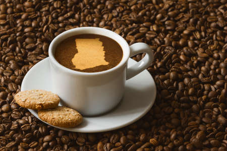 Still life photography of hot coffee beverage with map of Ghanaの写真素材