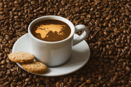 Still life photography of hot coffee beverage with map of Afro-EurAsiaの写真素材