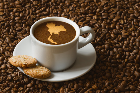 Still life photography of hot coffee beverage with map of Thailandの写真素材