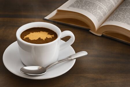 Still life photography of hot coffee beverage with map of Switzerlandの写真素材