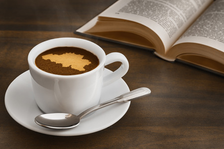 Still life photography of hot coffee beverage with map of  Belgiumの写真素材
