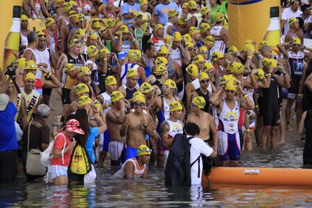 CAMARINES SUR- Aug. 14: Participants of Cobra Energy Drink Ironman 70.3 Philippines at the starting line in the swimming race event in Camarines Sur, Philippines on Sunday August 14, 2011.のeditorial素材