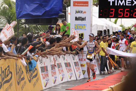 CAMARINES SUR- Aug. 14: Pete Jacobs of Australia winning the Cobra Energy Drink Ironman 70.3 Philippines in Camarines Sur, Philippines on Sunday August 14, 2011.のeditorial素材