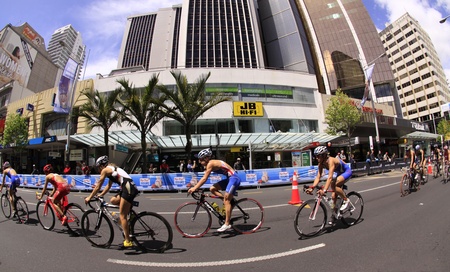 AUCKLAND, New Zealand- Oct. 20,2012: Women participants in the ITU World Triathlon Grand Finale Series cycle the main street of downtown Auckland.のeditorial素材