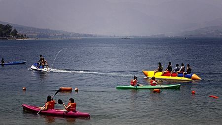 SUBIC-APR. 10: Filipino tourists paddling as kayak and riding a banana boat taken on April 10, 2009...