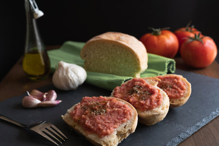Spanish tumaca bread toast with bread, tomato, garlic and olive oil.の写真素材