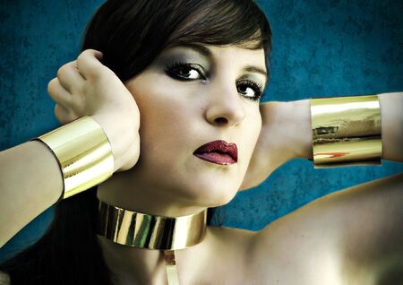 beauty portrait of model with golden jewelryの写真素材