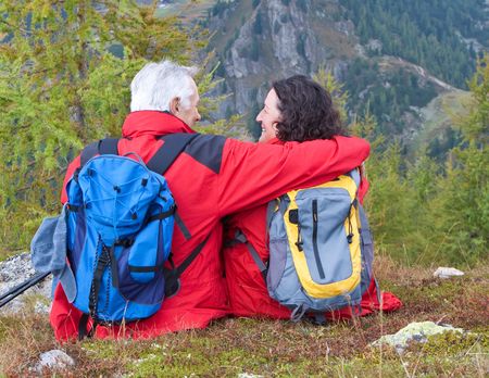 cute seniorcouple hiking in an autumn mountainlandscapeの写真素材
