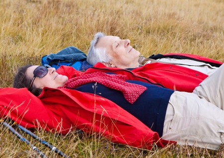 cute seniorcouple hiking in an autumn mountainlandscapeの写真素材