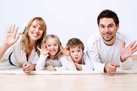 sweet young family having fun on the floor in their homeの写真素材