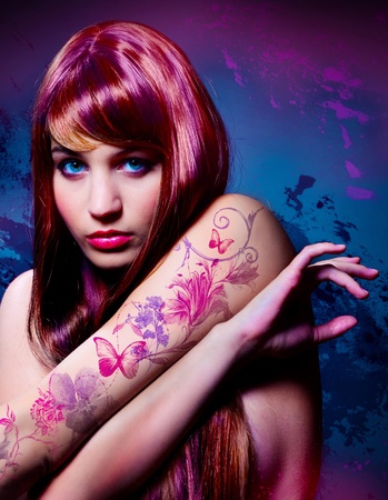 beautiful girl with colored hair and tattooの写真素材
