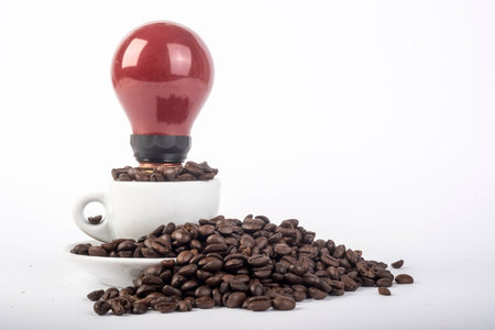 Coffee beans in the cup with red light bulbの写真素材