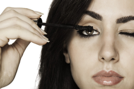 Closeup of beautiful girl putting make up onの写真素材