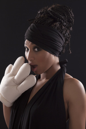 Beautiful surprised model wearing a black dress and a big handの写真素材