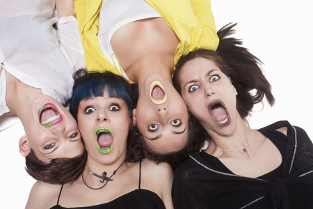 Beautiful and surprised women with painted lipsの写真素材