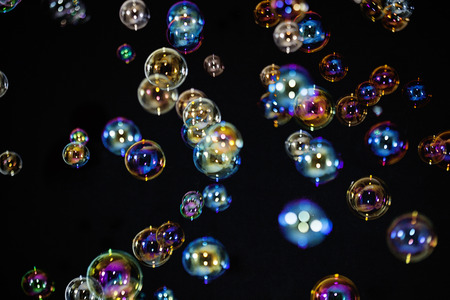Soap colorful bubbles on black backgroundの写真素材
