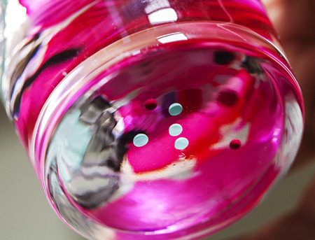 Crazy colorful nail polish effect in a glass of water