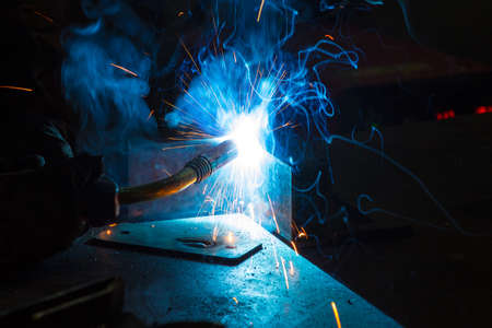 Worker welding construction by MIG welding, Worker welding the steel part by manual, welding splatter repairmanの写真素材