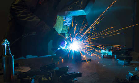 Worker welding construction by MIG welding, Worker welding the steel part by manual, welding splatter repairmanの写真素材