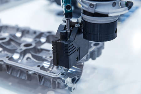 CNC Machine Robotic arm for silicone injection on cylinder head cover, gasket sealantの写真素材